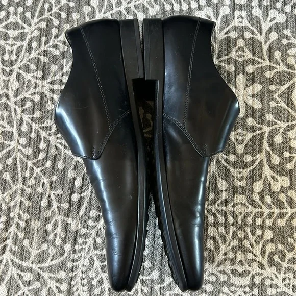 Tod’s black buckle loafers